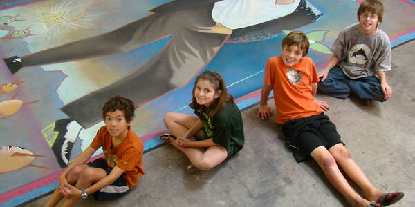 ACX Kids students pose with their supersize chalk drawing