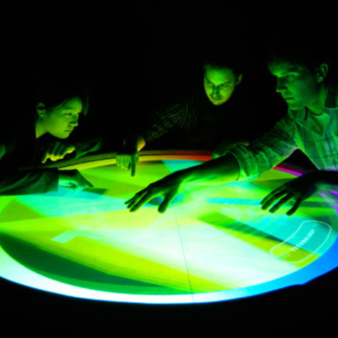 /Interactive table with people engaging with it by Jonathan Jarvis