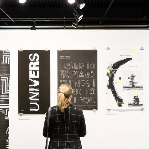 woman looking at artwork on the wall