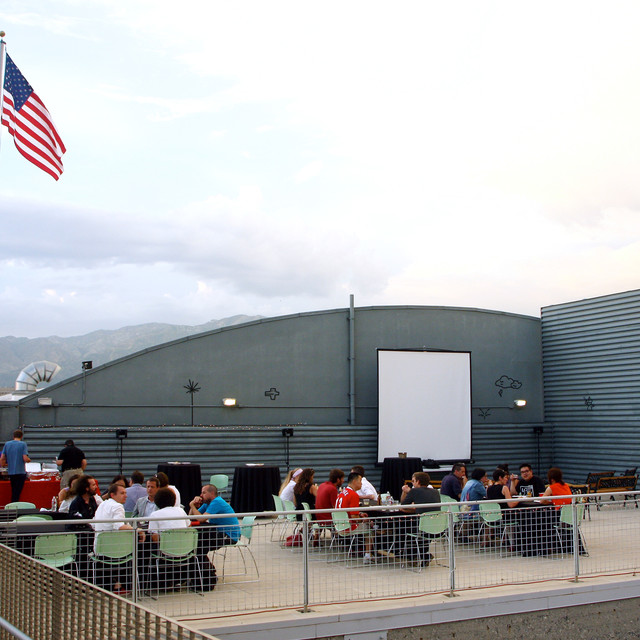 students sit a dining tables on the 950 rooftop