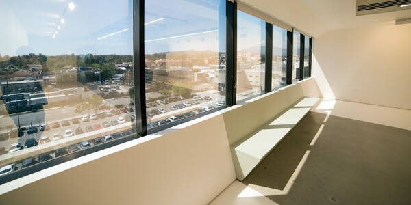 Windows on the sixth floor of the 1111 building with a view to the surrounding cityscape