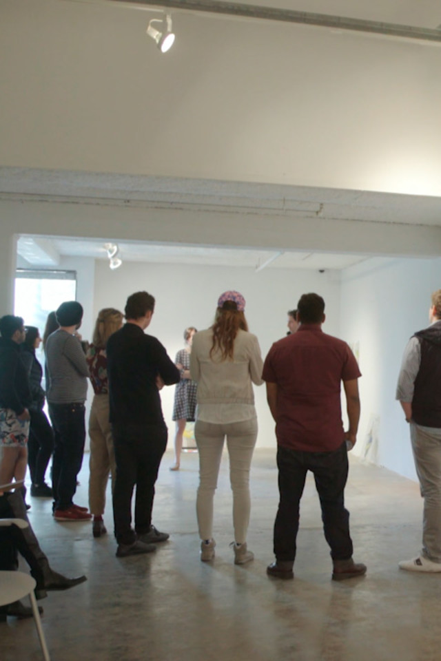 people observing artwork in a gallery