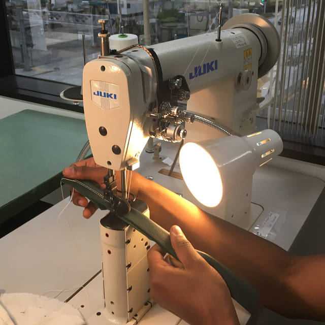 A students sewing on an industrial sewing machine