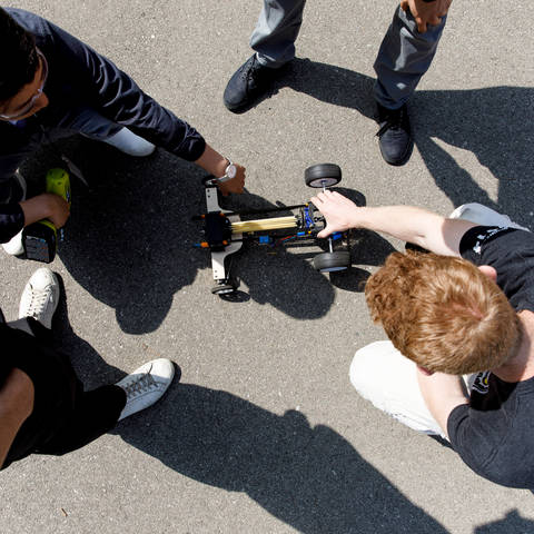 students setting up rubber band car